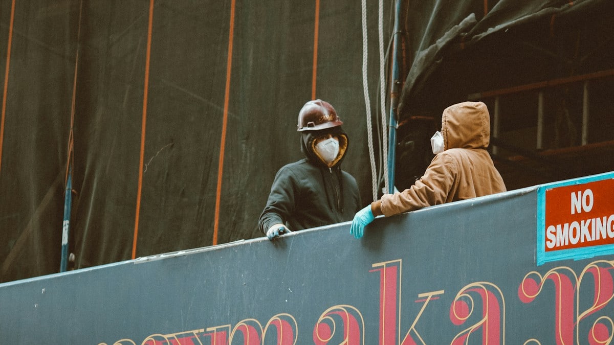 2 person wearing brown jacket and black helmet